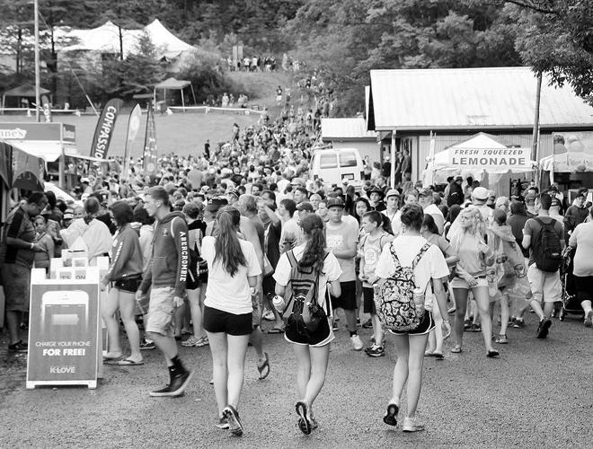 A dense crowd walking along the rain-soaked vendor path at Creation Northeast in 2014
