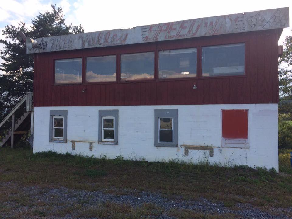 Abandoned red and white Hill Valley Speedway control building in 2017