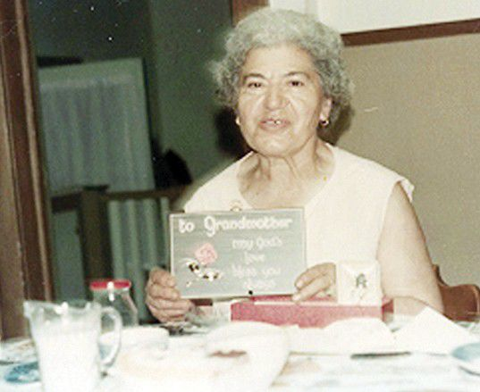Helen Popa holding a greeting card from one of her grandchildren in the kitchen of her Mount Union home