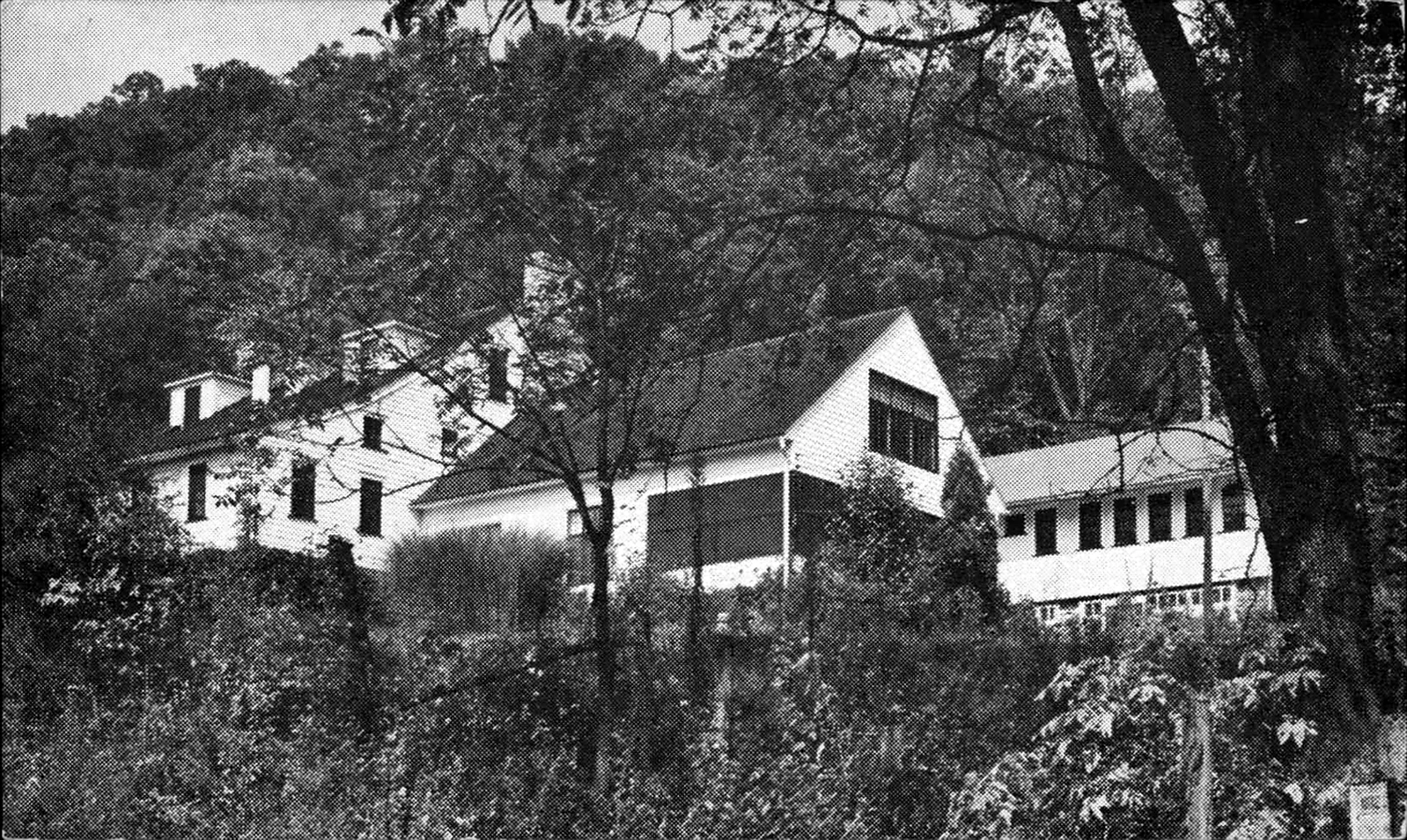 Historic black-and-white postcard view of Beacon Lodge buildings against the wooded mountainside