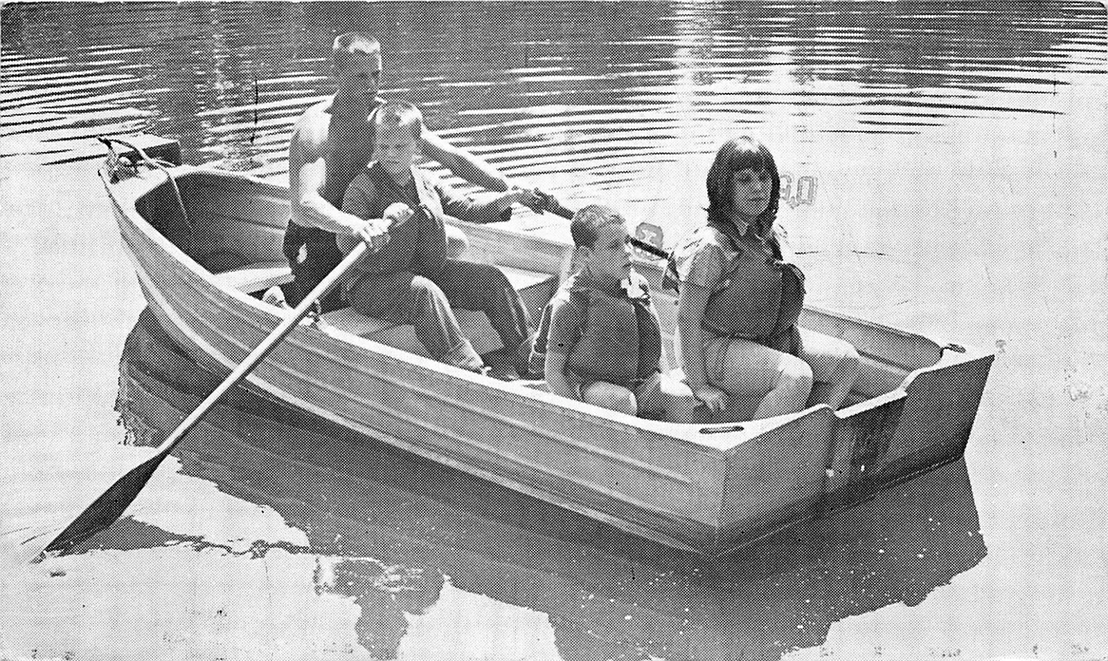 Four people rowing in a boat on the water at Beacon Lodge in 1974