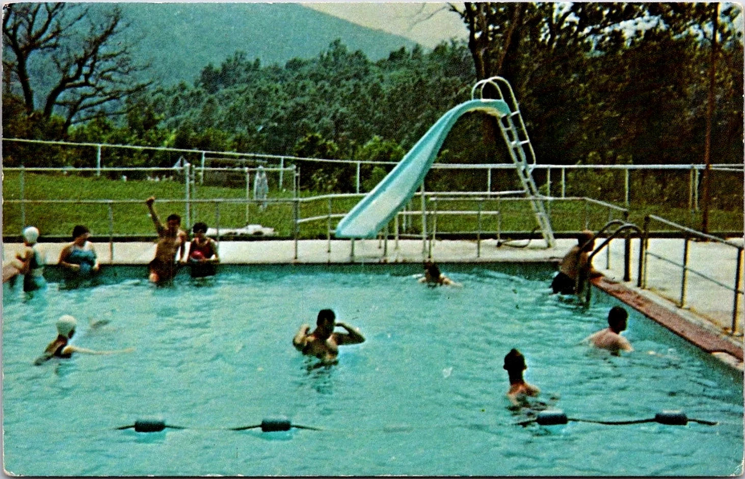 Campers in the Beacon Lodge swimming pool with an accessible ramp and slide