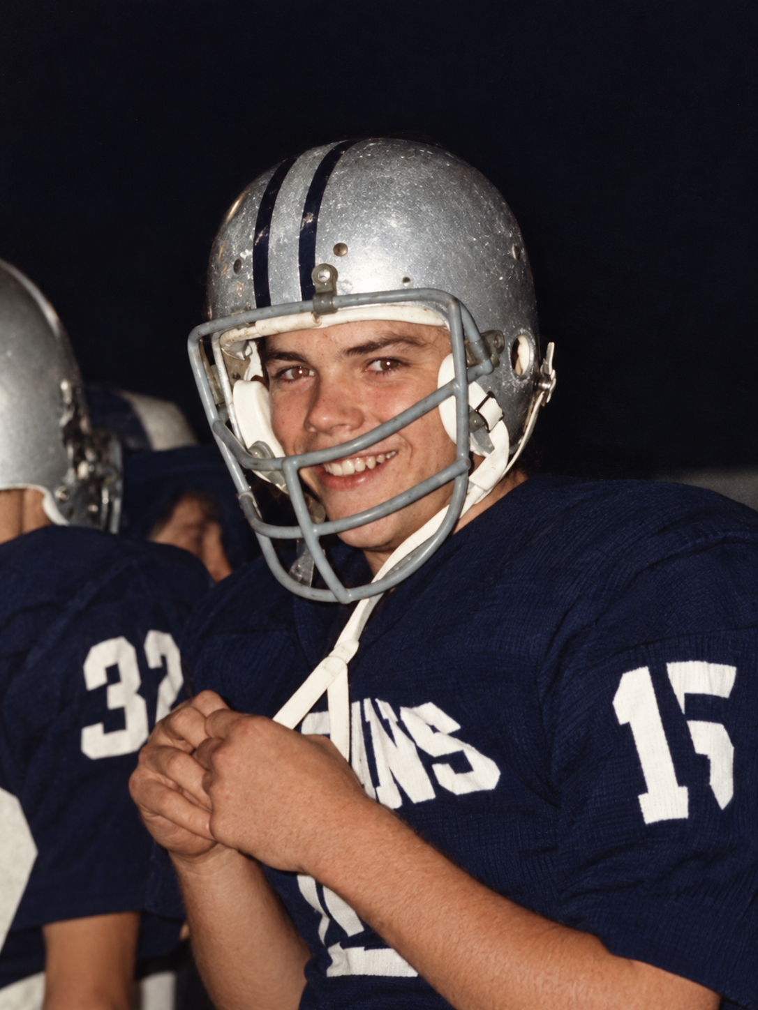 Brian Lewis smiling in his silver helmet and Mount Union No. 15 jersey