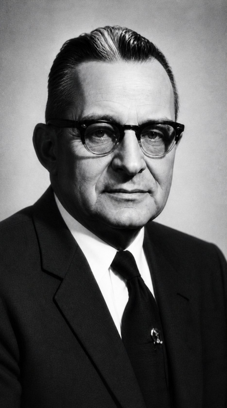 Black-and-white portrait of David Clair Goodman wearing glasses and a suit